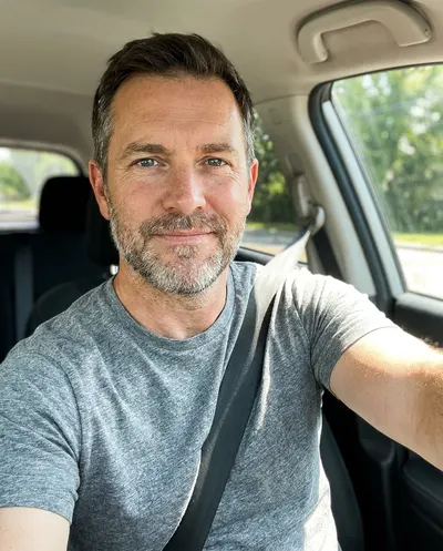 Example selfie of a man in his 40s in his car