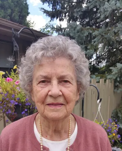 Example photo of a woman in her 70s in her garden